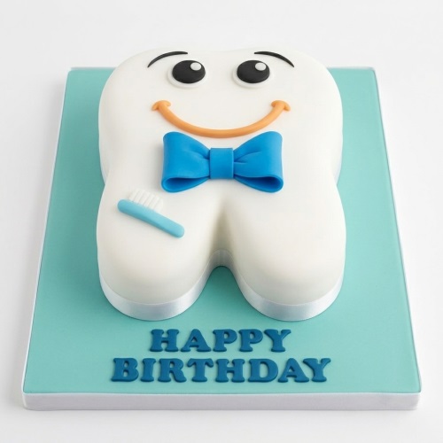 White tooth-shaped birthday cake with a happy face, blue bow tie, and a small blue toothbrush on a light blue board with 'Happy Birthday' text.
