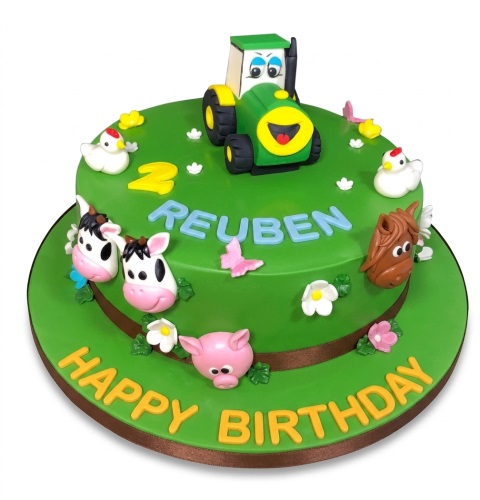 Two-tiered green farm birthday cake with a tractor, cows, pig, horse, chickens, and flowers.