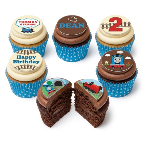 Thomas & Friends themed cupcakes with blue and brown frosting, featuring Thomas, James, railway tracks, and custom age/name toppers.