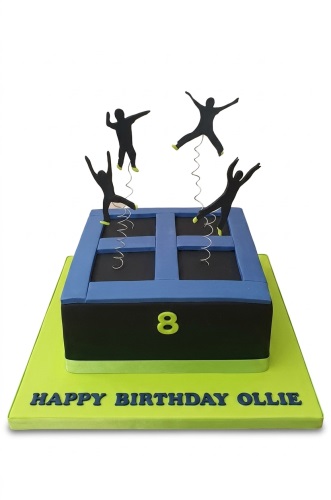 Square trampoline themed birthday cake with black and blue design, lime green accents, and four jumping silhouette figures. Features a custom age number and personalised message on the board.