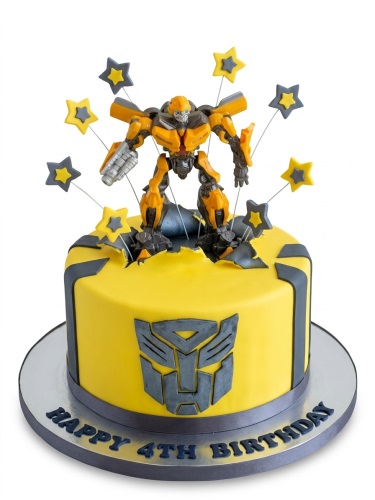 Yellow Transformers Bumblebee birthday cake with grey Autobot logo and star decorations.
