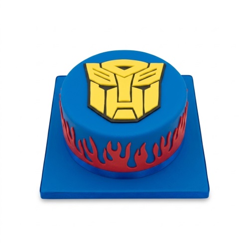 Round blue Transformers birthday cake with yellow Autobot logo and red flame details.