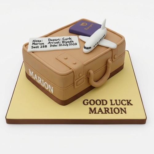 Tan suitcase-shaped travel theme cake with white airplane, purple passport, and custom flight tag on a yellow board.