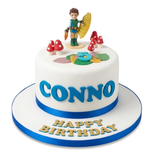White round adventure theme birthday cake with male character, mushrooms, leaves, custom age topper, and personalised name.