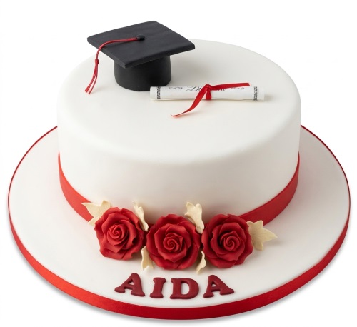 White round graduation cake with a black cap, diploma scroll, and red sugar roses.