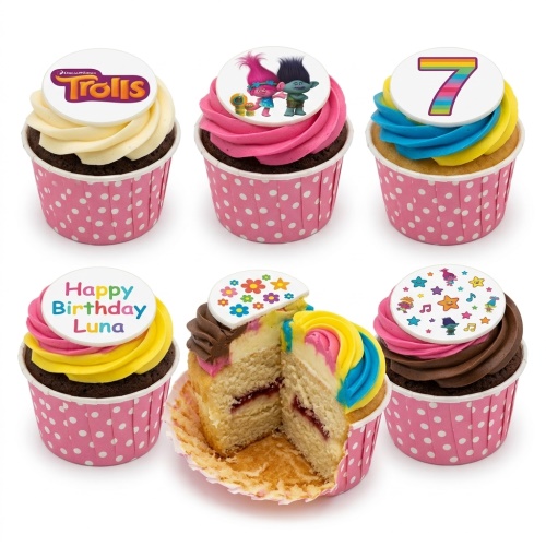 Trolls themed cupcakes with logo, characters, rainbow number 7, and a personalised 'Happy Birthday' message topper in pink polka dot wrappers.