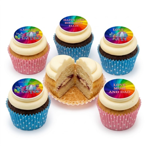 Trolls themed birthday cupcakes with rainbow toppers and white frosting in pink and blue polka dot wrappers.