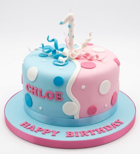 Blue and pink polka dot birthday cake with a custom age candle.
