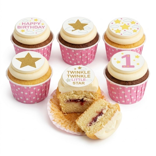 Six cupcakes with white icing, pink polka dot wrappers, and star-themed edible toppers, including a custom age '1' and 'Happy Birthday' message.