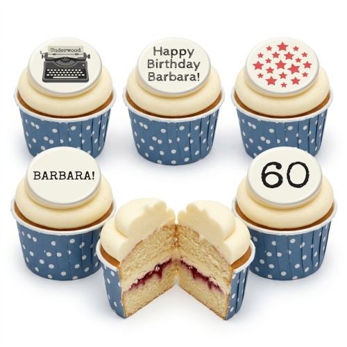 Six vanilla cupcakes with white frosting and blue polka dot cases. Toppers include a vintage typewriter, red stars, and custom messages.