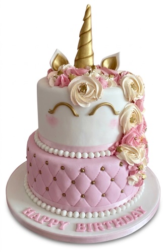 Two-tier unicorn birthday cake with golden horn, ears, pink and cream rosettes, and quilted pink bottom tier.
