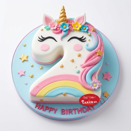 Unicorn-shaped birthday cake with rainbow mane, golden horn, flowers, and stars on a blue board.
