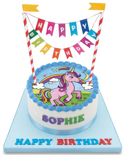 Round white birthday cake with a unicorn and rainbow edible image, blue piped border, and 'Happy Birthday' banner topper.