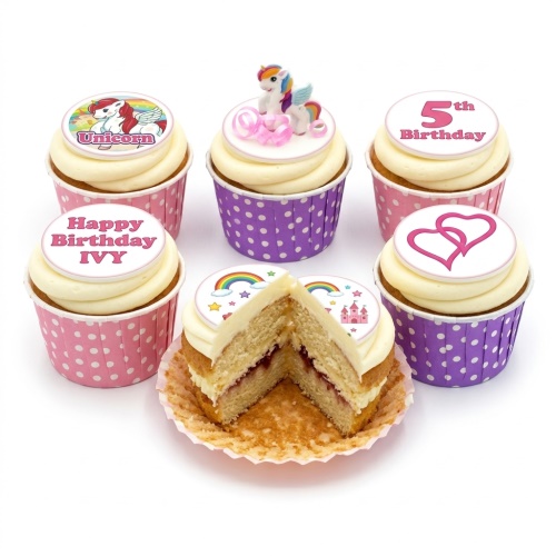 Unicorn themed birthday cupcakes with rainbow, castle, and heart decorations, featuring a custom age topper.