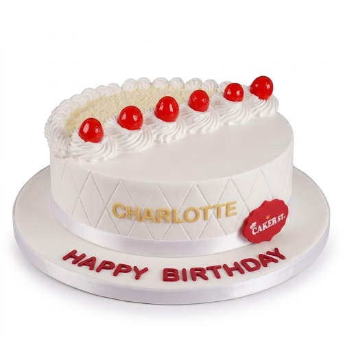 White birthday cake with red cherries, white cream swirls, and a quilted pattern. Features a personalised name and 'Happy Birthday' message.