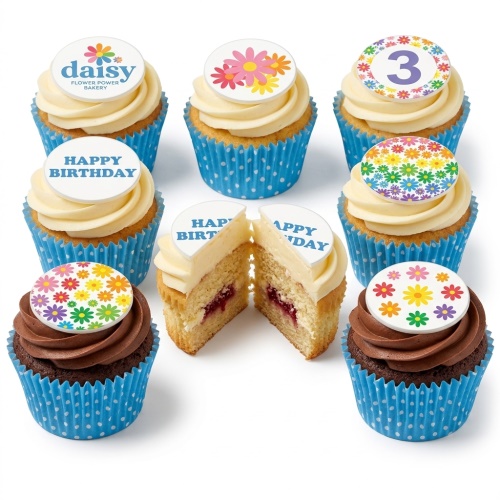 Assorted cupcakes with white and chocolate frosting, blue polka dot wrappers, and colourful floral and custom age toppers.