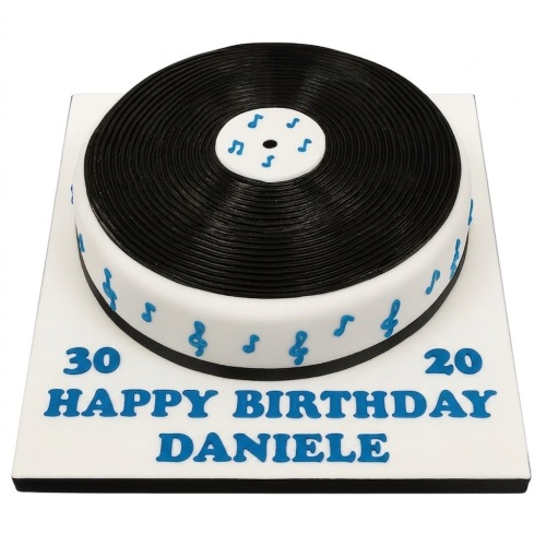 Round white cake with a black vinyl record on top and blue musical notes around the side.