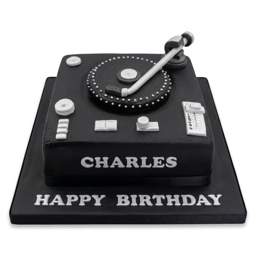 Black square birthday cake with a white and black turntable on top, and a white 'Happy Birthday' message.