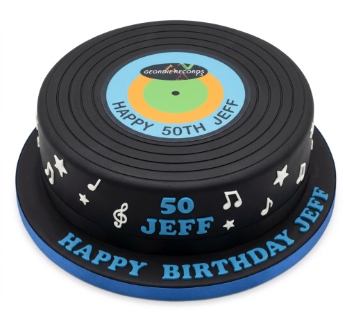 Round black vinyl record themed birthday cake with musical notes and custom age