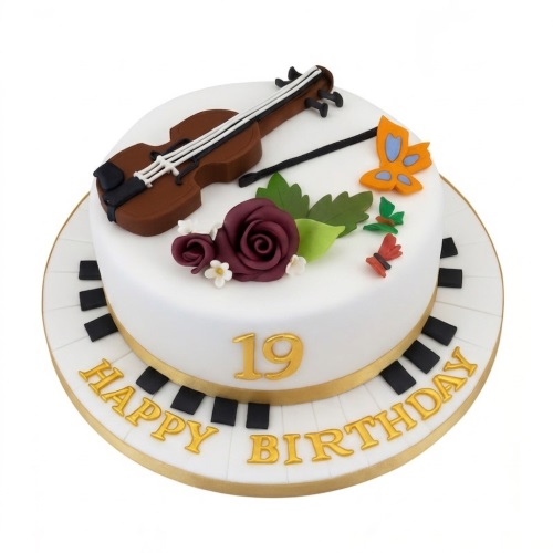 White two-tier birthday cake with a brown violin, burgundy roses, green leaves, colourful butterflies, and a piano key base with gold 'Happy Birthday' lettering.