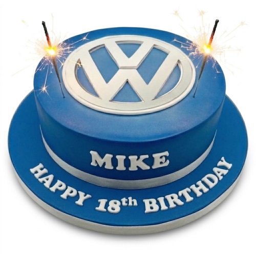 Round blue fondant cake with a silver Volkswagen logo on top, silver trim, and white personalised text on the side and board, with sparklers.