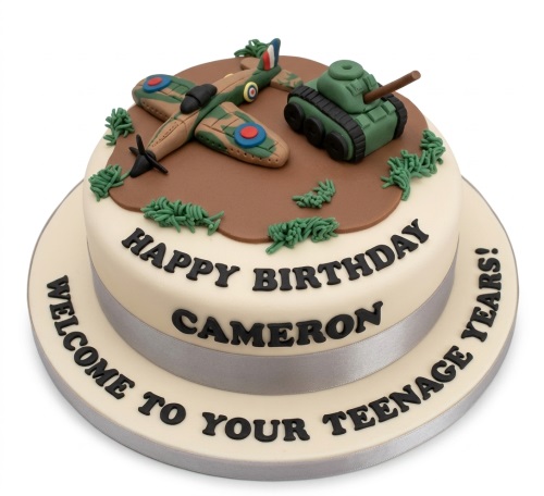 Round military theme birthday cake with fondant aeroplane, tank, and green foliage.