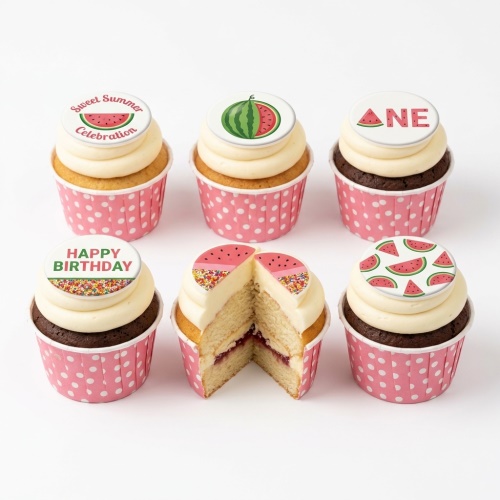 Watermelon themed birthday cupcakes with white frosting, pink polka dot wrappers, and various edible toppers including watermelon slices, whole watermelons, 'Happy Birthday', 'Sweet Summer Celebration', and 'ONE'.