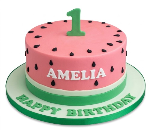 Round pink and green watermelon birthday cake with black seeds, a green number topper, and a personalised name.