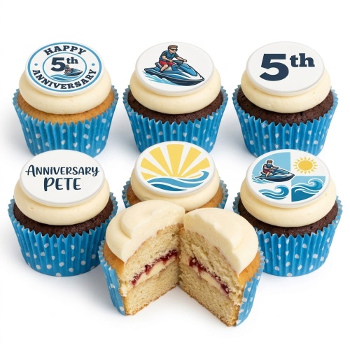 Cupcakes with jet ski and waves toppers, some showing custom anniversary numbers and names, in blue polka dot cases.