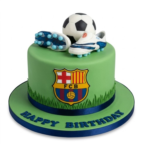 Round green FC Barcelona football birthday cake with edible football, boots, and FCB logo on a cake board with 'Happy Birthday' text.