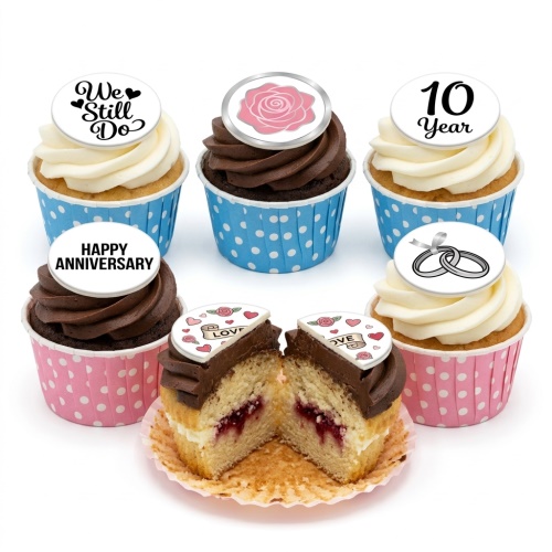 Anniversary cupcakes with white and chocolate frosting, topped with romantic messages, a pink rose, and wedding rings.