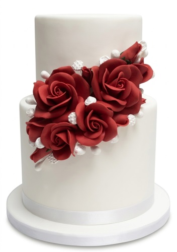 Two-tier white cake with red sugar roses and white pearl decorations