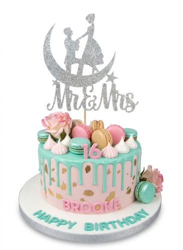 Pink and mint green drip cake with macarons, roses, and a custom age topper.