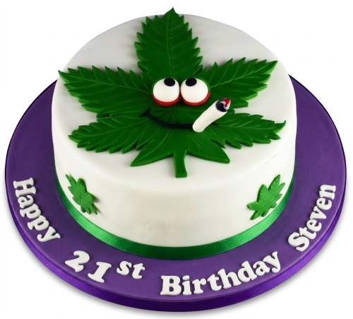 Round white cake with a large green cannabis leaf character, cartoon eyes, and a joint, on a purple cake board with custom age and name.