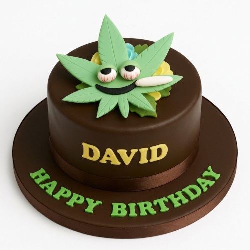 Round dark brown novelty cake with a green cannabis leaf character and personalised message.