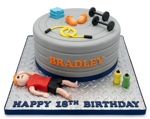 Grey gym themed birthday cake with dumbbells, skipping rope, trainers, and an exhausted figure on a diamond plate board.