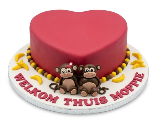 Heart-shaped red cake with two fondant monkeys, bananas, and a custom message.