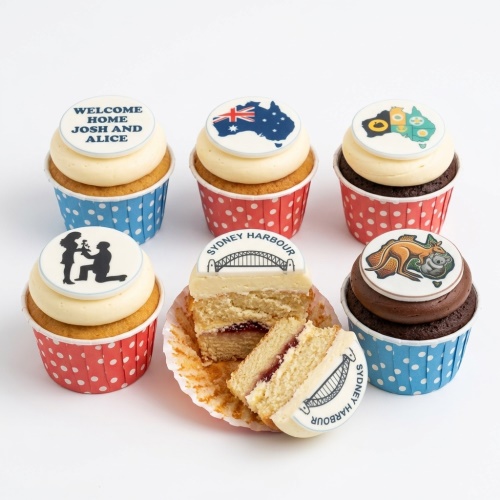 Australia themed cupcakes with flag, map, animals, Sydney Harbour Bridge, and custom message toppers.