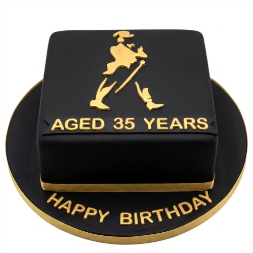 Black square cake with gold striding man logo and 'Aged 35 Years' text, on a black and gold board with 'Happy Birthday'.
