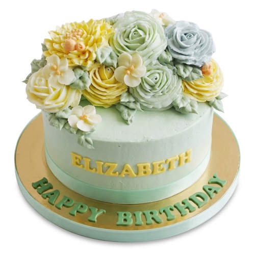 Round pastel green birthday cake with yellow, green, and blue buttercream flowers and custom name.