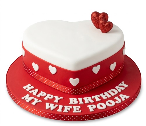 Red and white heart-shaped birthday cake with glitter hearts and custom message.