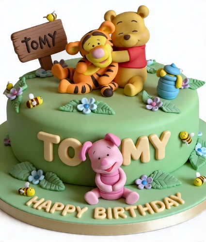 Green Winnie the Pooh birthday cake with edible figures of Pooh, Tigger, and Piglet, decorated with bees and flowers.