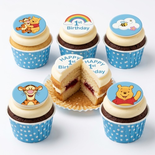 Winnie the Pooh 1st Birthday Cupcakes with Tigger, Pooh, rainbow, and bee toppers on vanilla and chocolate sponges.