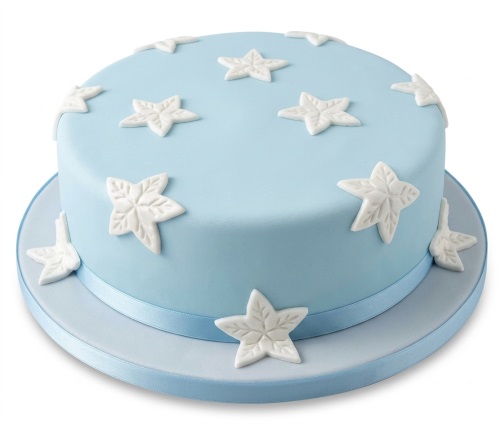 Light blue round cake with white star decorations and blue ribbon
