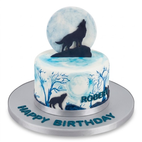 Round white and blue birthday cake with wolf howling at moon design and personalised message.