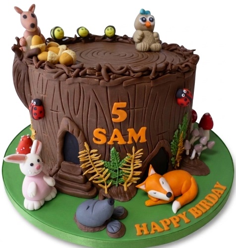 Woodland animal themed birthday cake shaped like a tree stump with a custom age topper and personalised name.