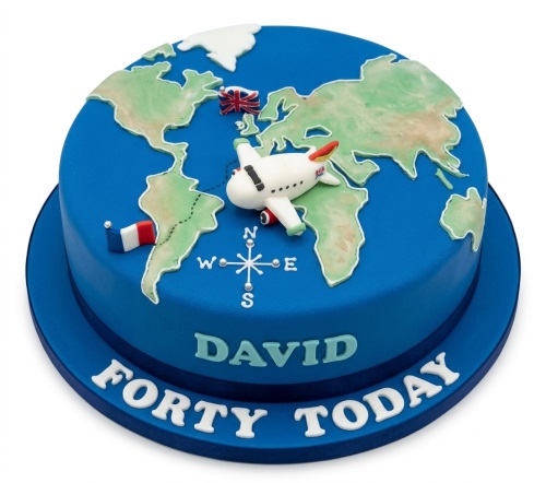 Round blue travel theme cake with world map, airplane, compass, and custom message.