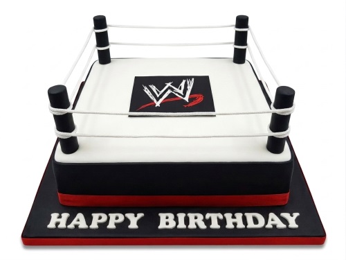 WWE wrestling ring birthday cake with black, white, and red design and 'Happy Birthday' message.