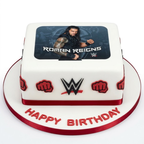 Square white fondant cake with Roman Reigns edible image, WWE logo, red fists, and 'Happy Birthday' message.