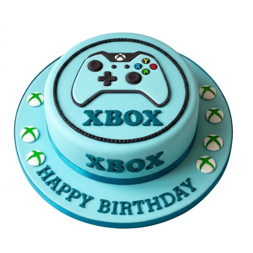 Two-tier light blue Xbox themed birthday cake with controller and Xbox logo decorations, and 'Happy Birthday' message.